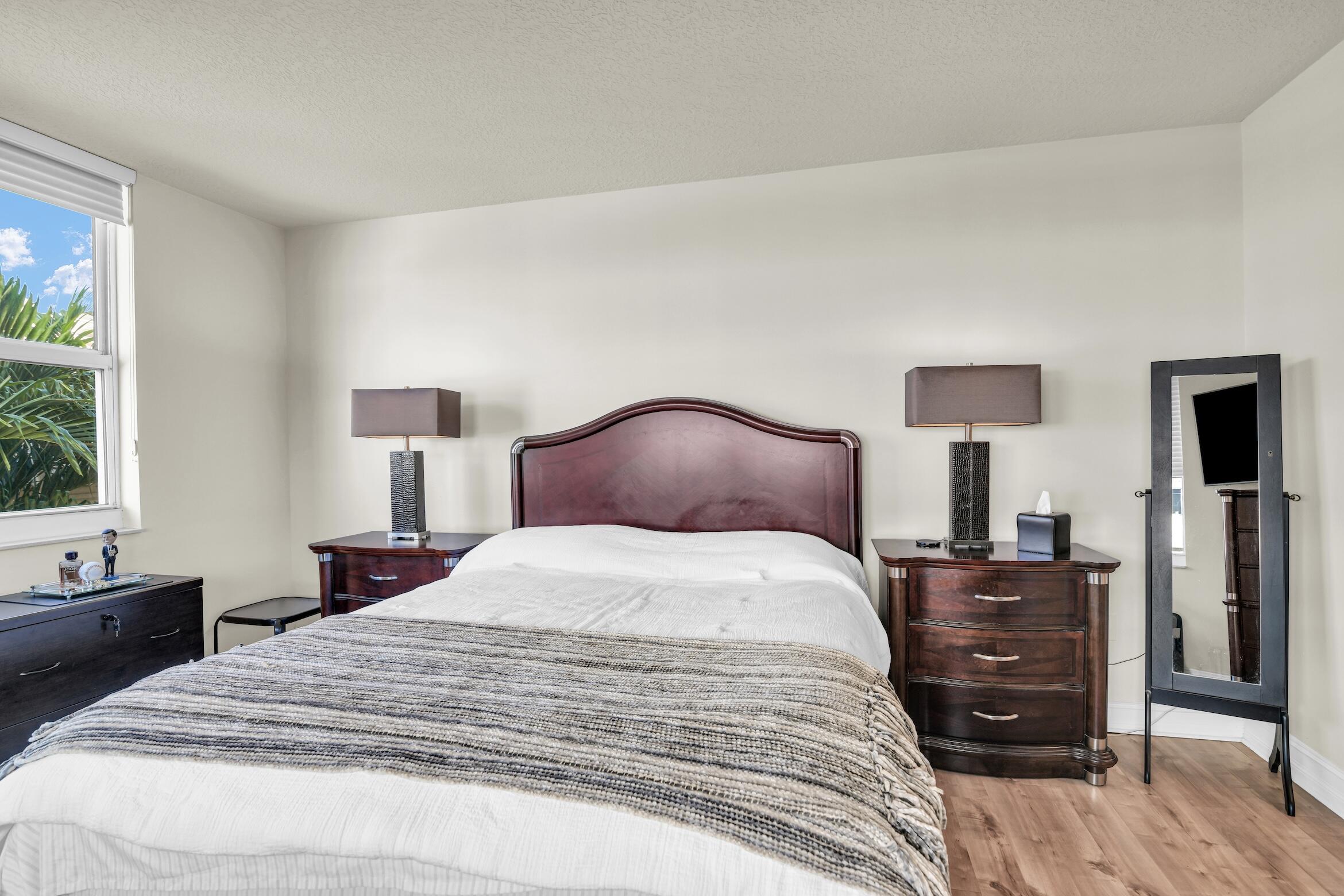 99 Southeast Mizner Boulevard, Unit 848 Boca Raton, FL 33432 - Photo 12 of 22 a bedroom with a bed and a tv on dresser