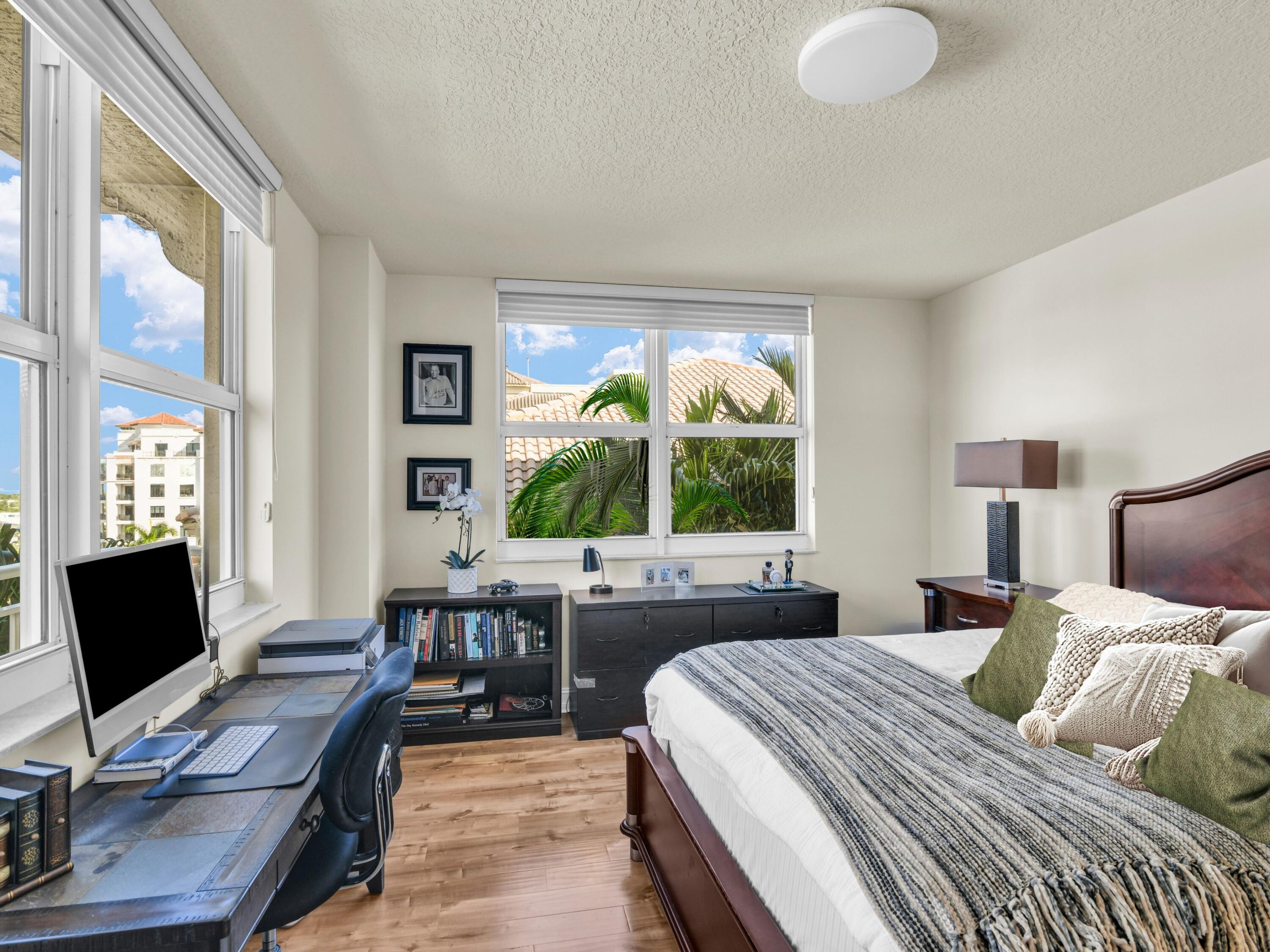 99 Southeast Mizner Boulevard, Unit 848 Boca Raton, FL 33432 - Photo 13 of 22 a bedroom with a bed and a desk