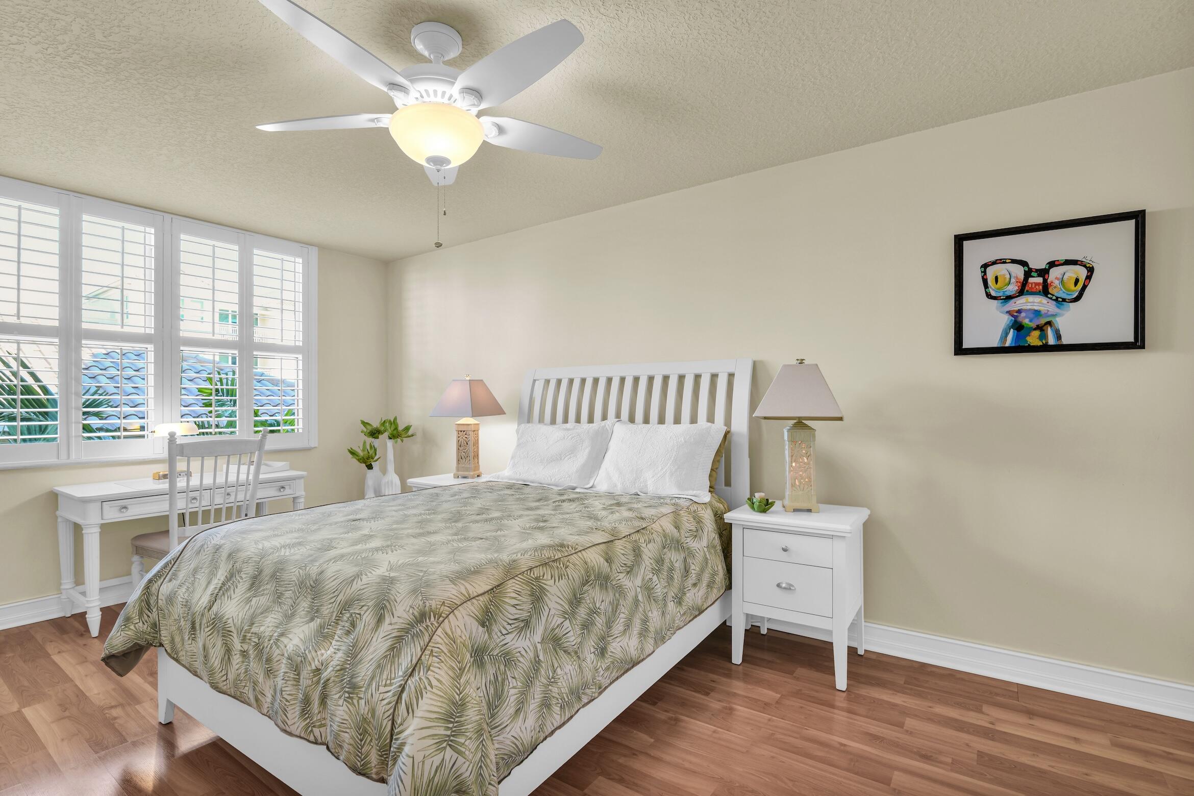 99 Southeast Mizner Boulevard, Unit 848 Boca Raton, FL 33432 - Photo 18 of 22 a large bed sitting in a bedroom next to a window