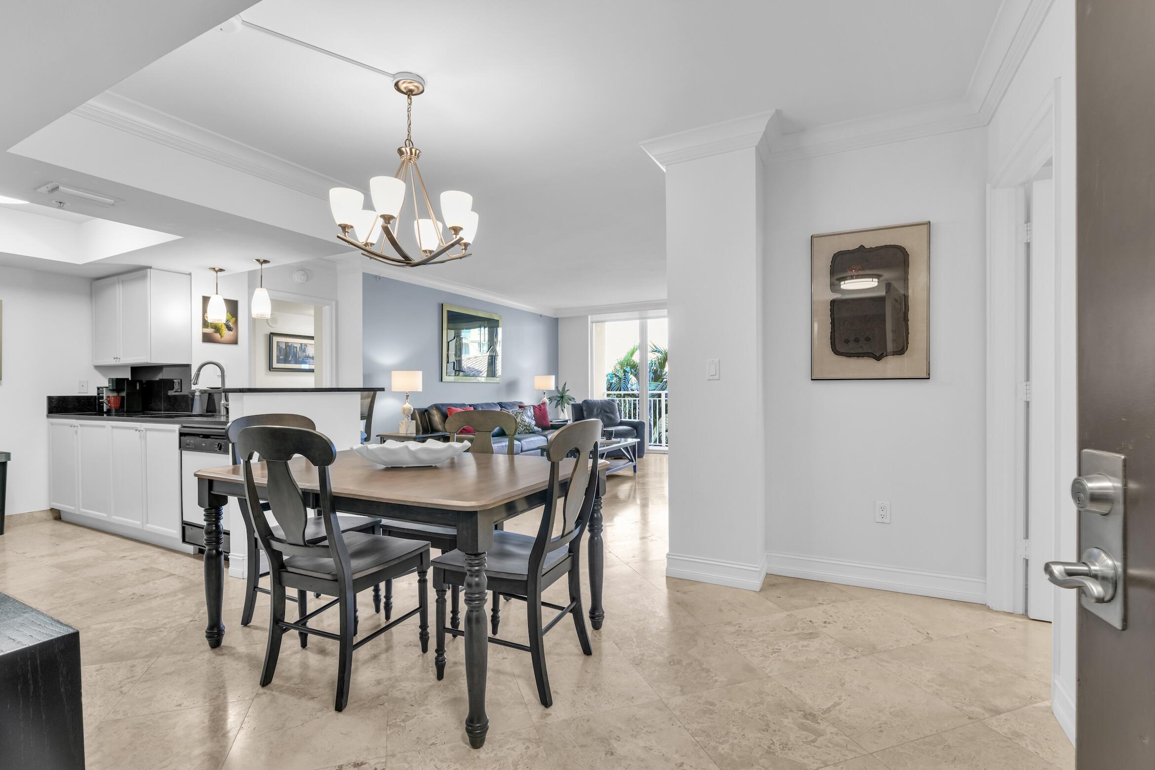 99 Southeast Mizner Boulevard, Unit 848 Boca Raton, FL 33432 - Photo 3 of 22 a view of a dining room with furniture and chandelier