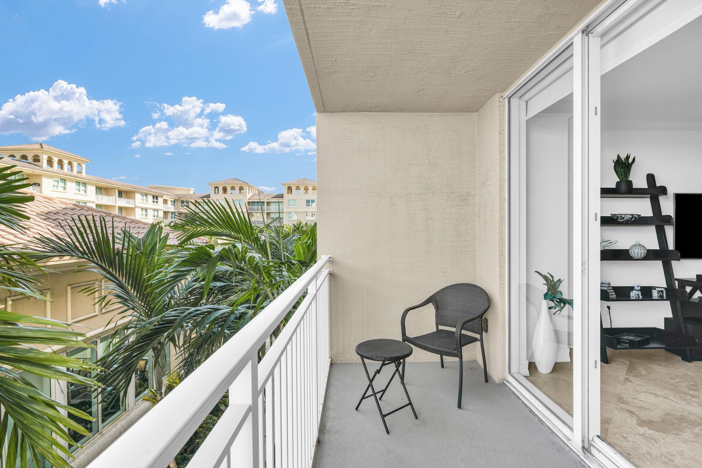 99 Southeast Mizner Boulevard, Unit 848 Boca Raton, FL 33432 - Photo 6 of 22 a view of a balcony with chair and front door