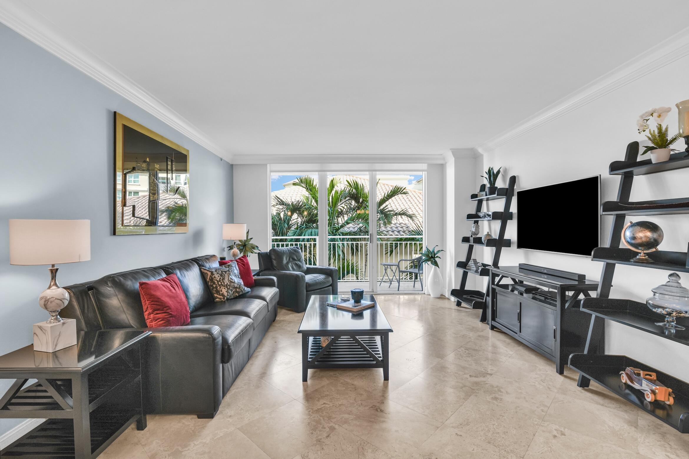 99 Southeast Mizner Boulevard, Unit 848 Boca Raton, FL 33432 - Photo 8 of 22 a living room with furniture and a flat screen tv