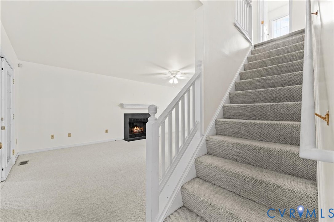 2924 Warfield Ridge Terrace Chester, VA 23831 - Photo 9 of 38 Carpeted staircase with white handrail and brass w