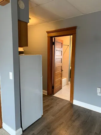an empty room with wooden floor and a window