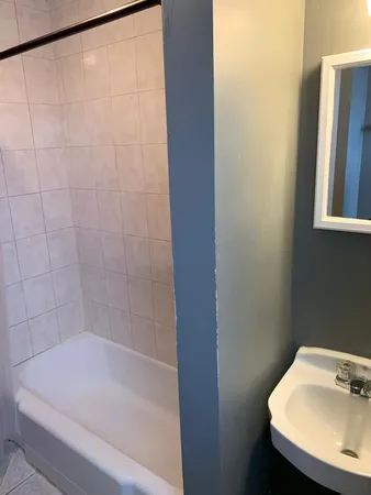 a bathroom with a bathtub and sink