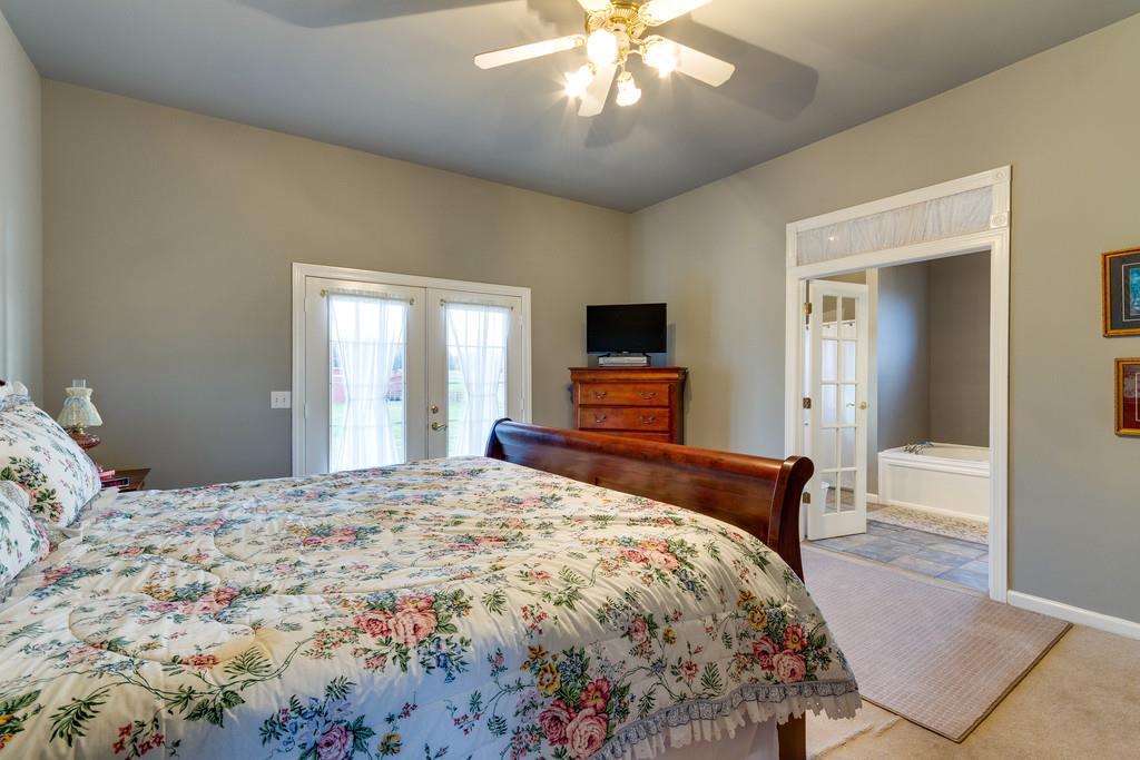 3960 Armstrong Road Springfield, TN 37172 - Photo 14 of 30 a bedroom with a bed and a chandelier