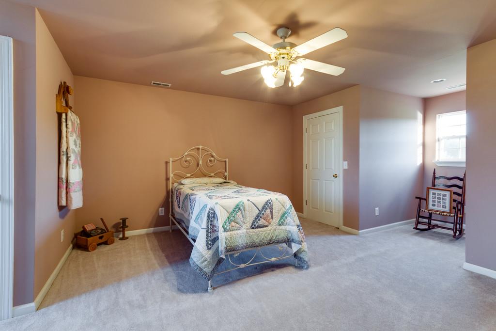 3960 Armstrong Road Springfield, TN 37172 - Photo 22 of 30 a spacious bedroom with a bed and a chandelier
