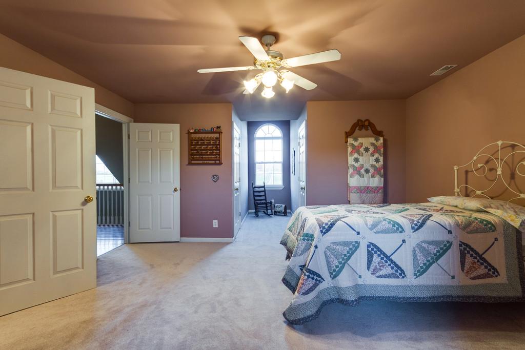 3960 Armstrong Road Springfield, TN 37172 - Photo 23 of 30 a bedroom with a bed and a chandelier