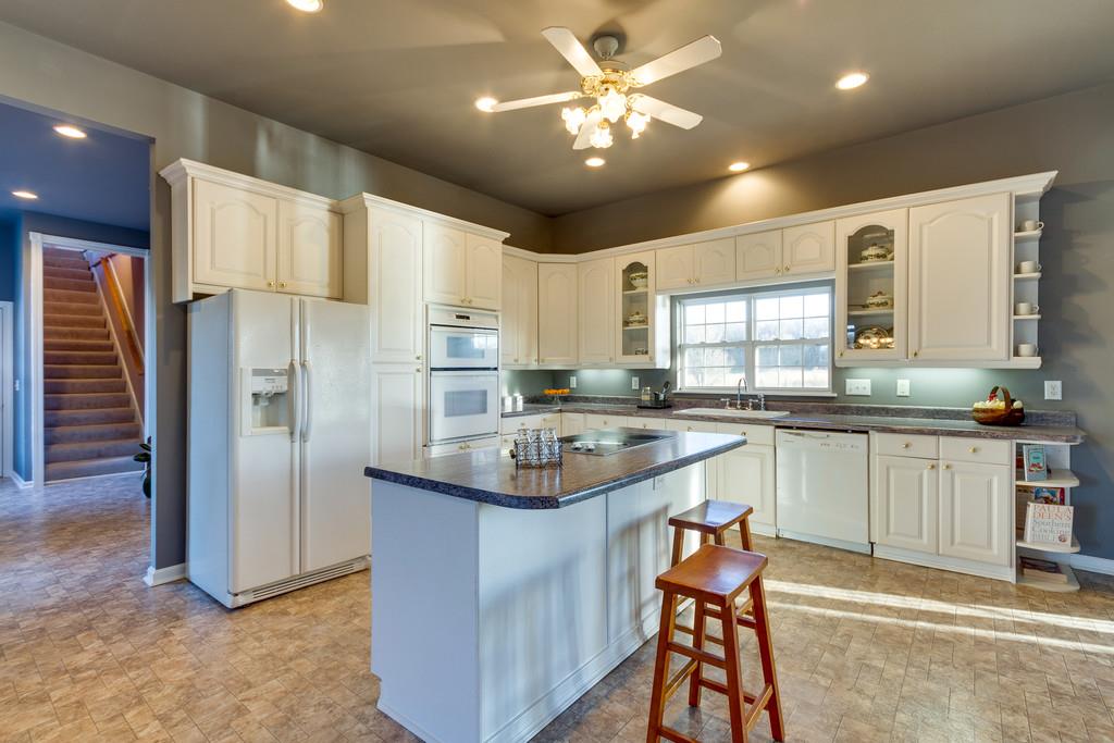 3960 Armstrong Road Springfield, TN 37172 - Photo 9 of 30 a kitchen with stainless steel appliances granite countertop white cabinets a sink a stove a refrigerator and island