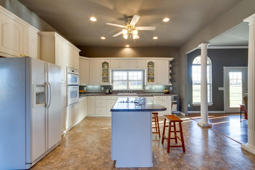 3960 Armstrong Road Springfield, TN 37172 - Photo 10 of 30 a kitchen with stainless steel appliances kitchen island granite countertop a refrigerator and a stove top oven