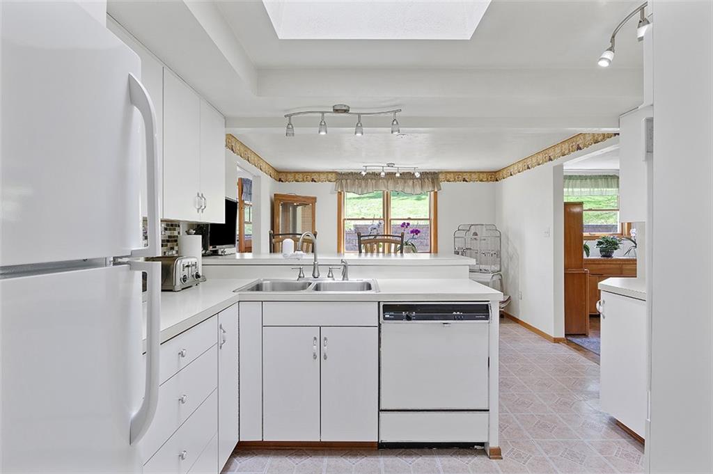 37 Coppola Road Cecil, PA 15321 - Photo 11 of 25 a large white kitchen with a sink and dishwasher with white cabinets