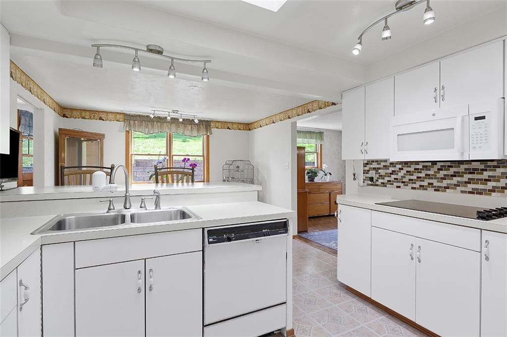 37 Coppola Road Cecil, PA 15321 - Photo 12 of 25 a kitchen with a sink dishwasher and white cabinets