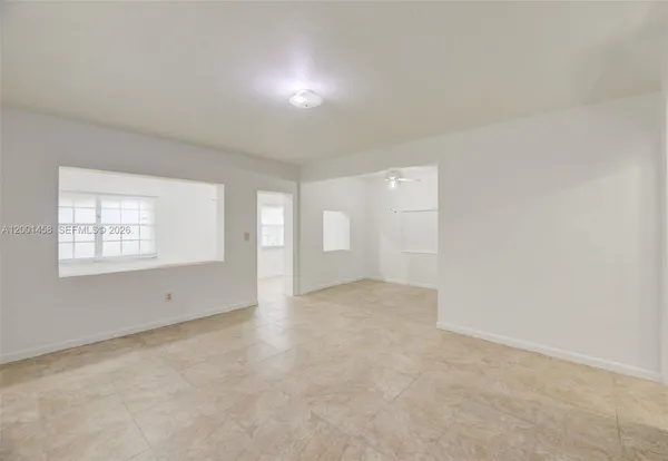 a view of a room with a stylish ceiling fan and entryway