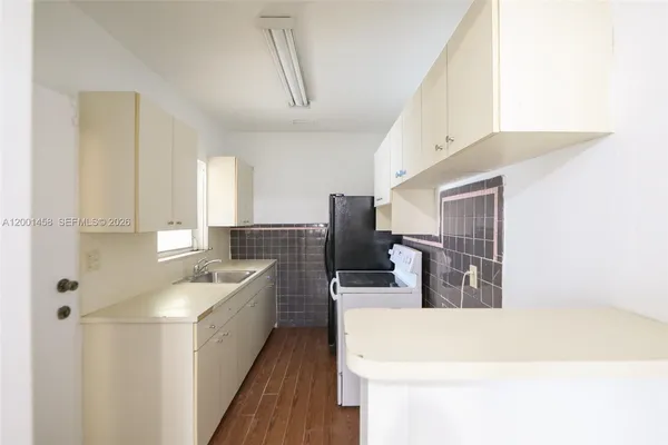a kitchen with a sink stove and refrigerator