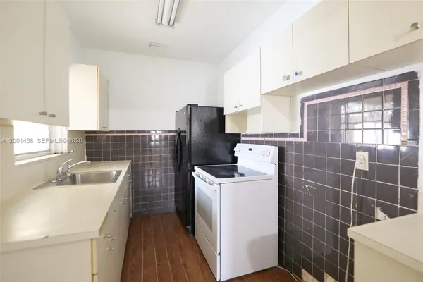 a kitchen with a refrigerator sink and stove