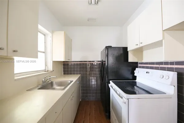 a kitchen with a sink cabinets and stainless steel appliances