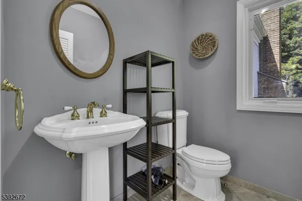 a bathroom with a toilet a sink and a mirror