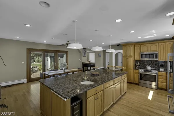 a kitchen with stainless steel appliances granite countertop a sink and a stove
