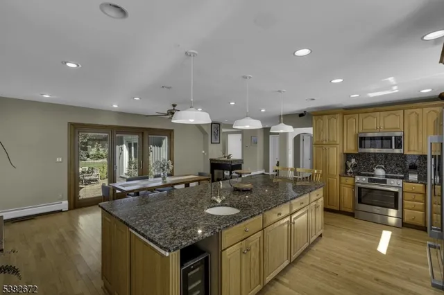 a kitchen with stainless steel appliances granite countertop a sink and a stove
