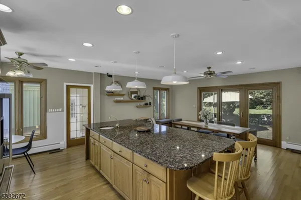 a kitchen with granite countertop kitchen island stainless steel appliances a sink and a counter top space
