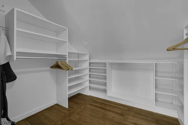 a view of walk in closet with empty racks