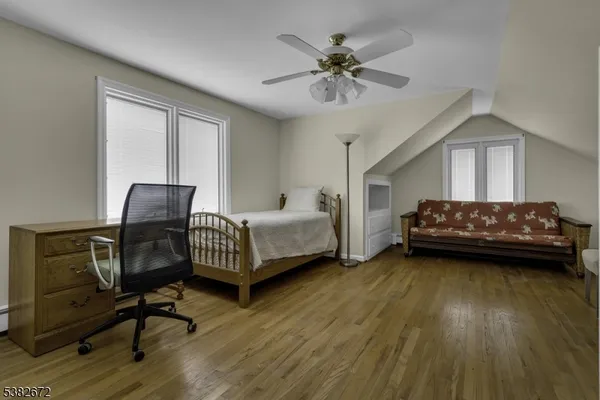 a bedroom with bed and a chandelier
