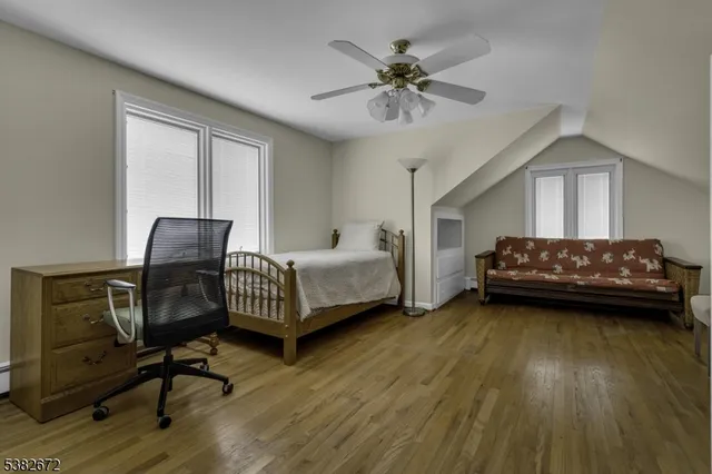 a bedroom with bed and a chandelier