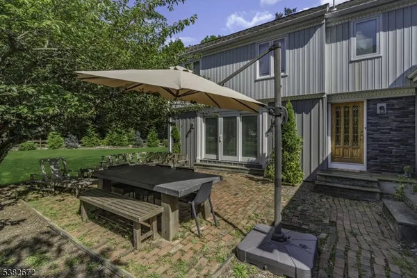 a view of a house with backyard and sitting area