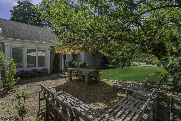 a view of a house with backyard and sitting area