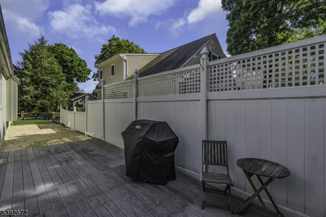 a view of a chairs and table in backyard
