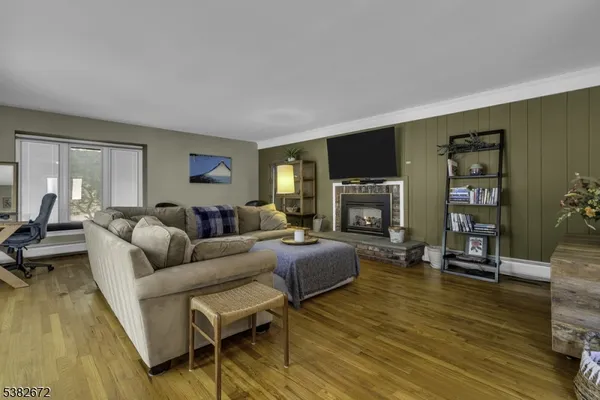 a living room with fireplace furniture and a flat screen tv