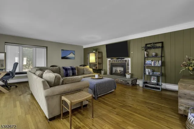 a living room with fireplace furniture and a flat screen tv