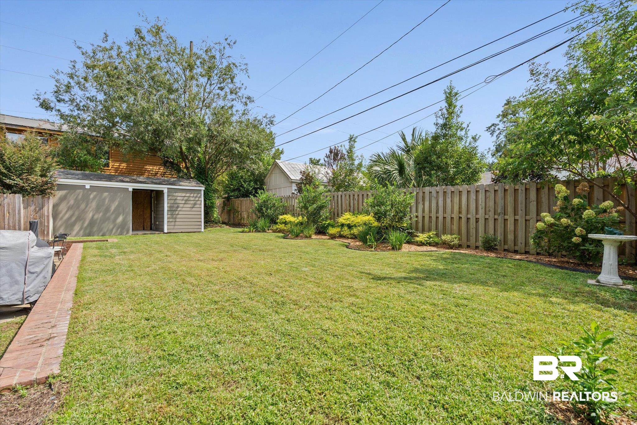 77 North Hathaway Road Mobile, AL 36608 - Photo 28 of 33 Fenced backyard featuring a shed