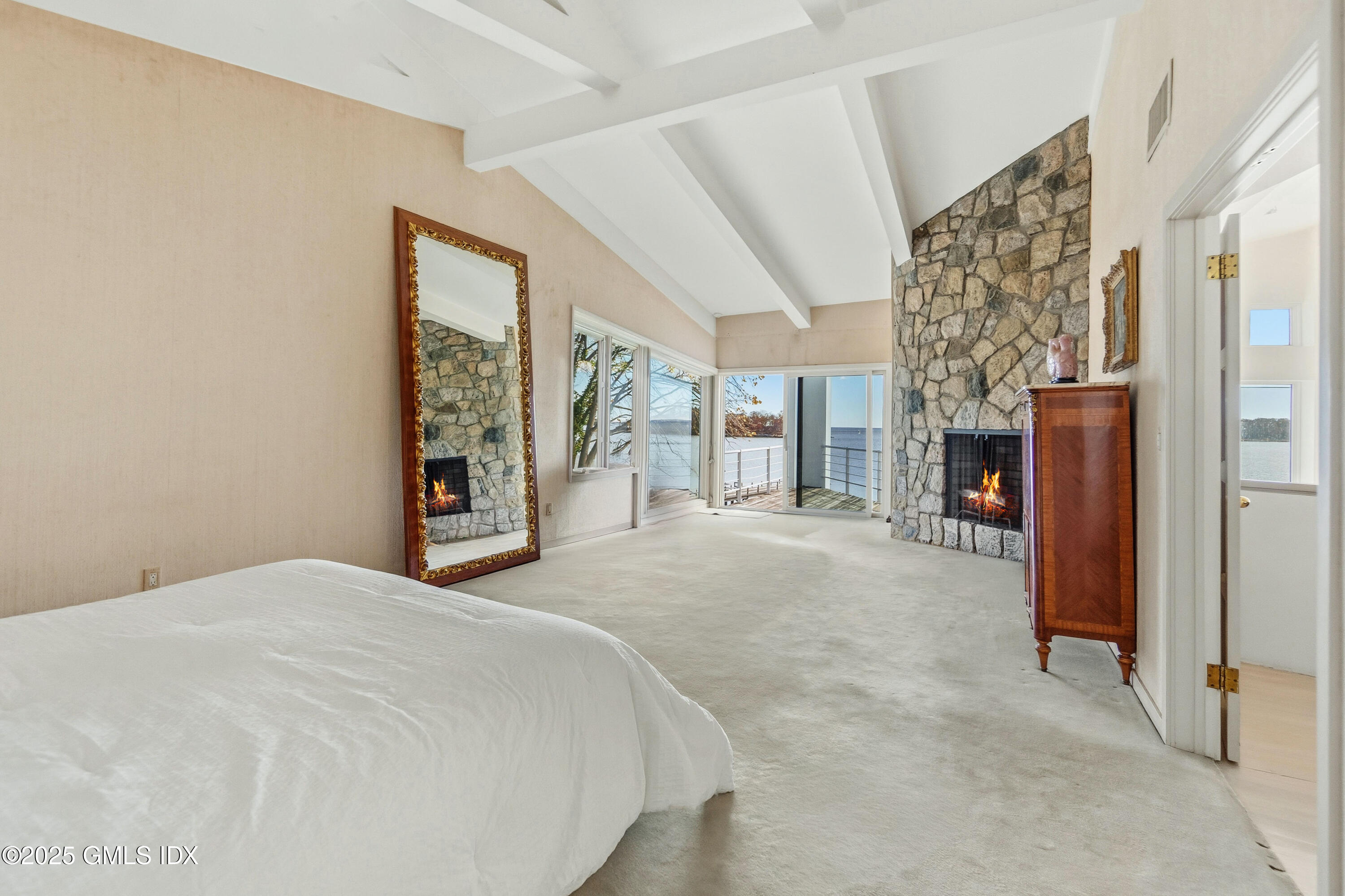 111 Byram Shore Road Greenwich, CT 06830 - Photo 13 of 23 a spacious bedroom with a large bed and a window