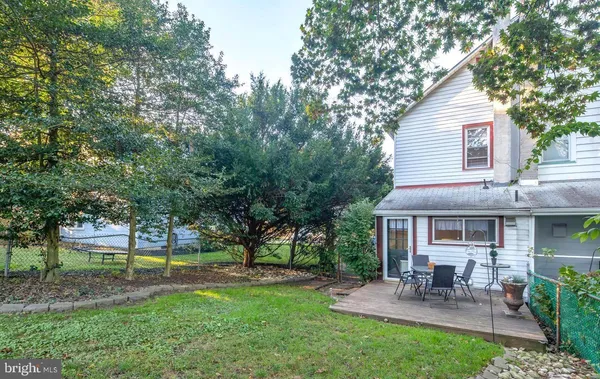 a view of a house with a yard and sitting area