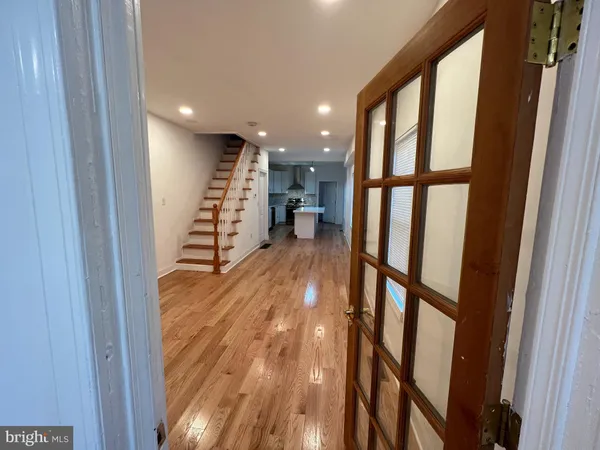 a view of entryway with stairs and wooden floor