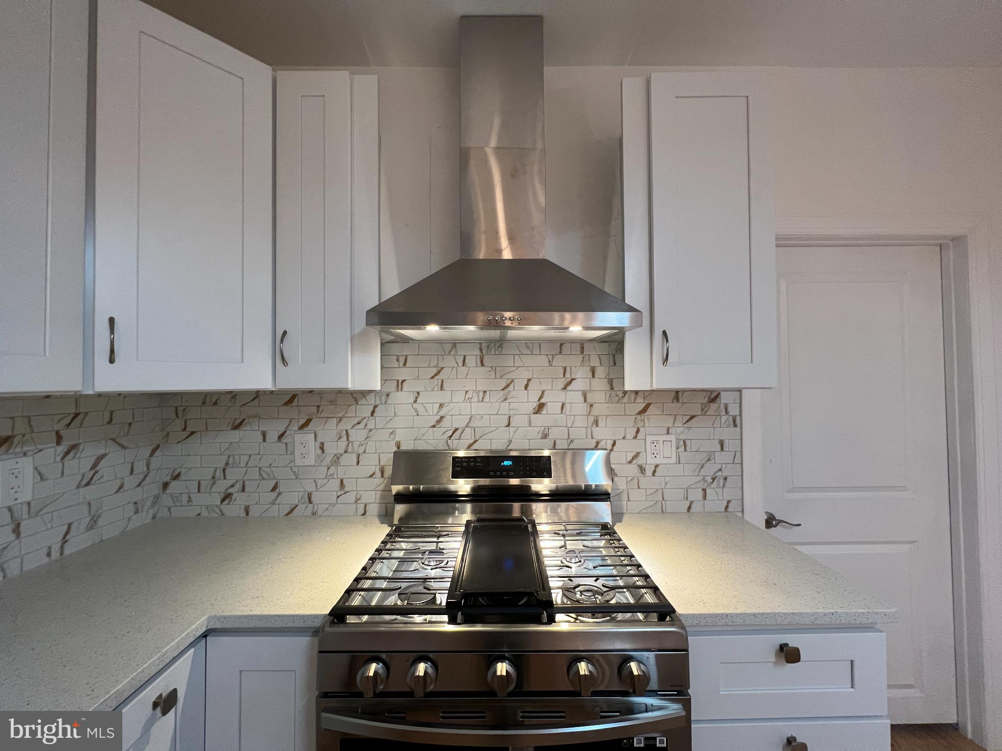 220 Lakeview Avenue Haddonfield, NJ 08033 - Photo 5 of 11 a kitchen with a stove and white cabinets