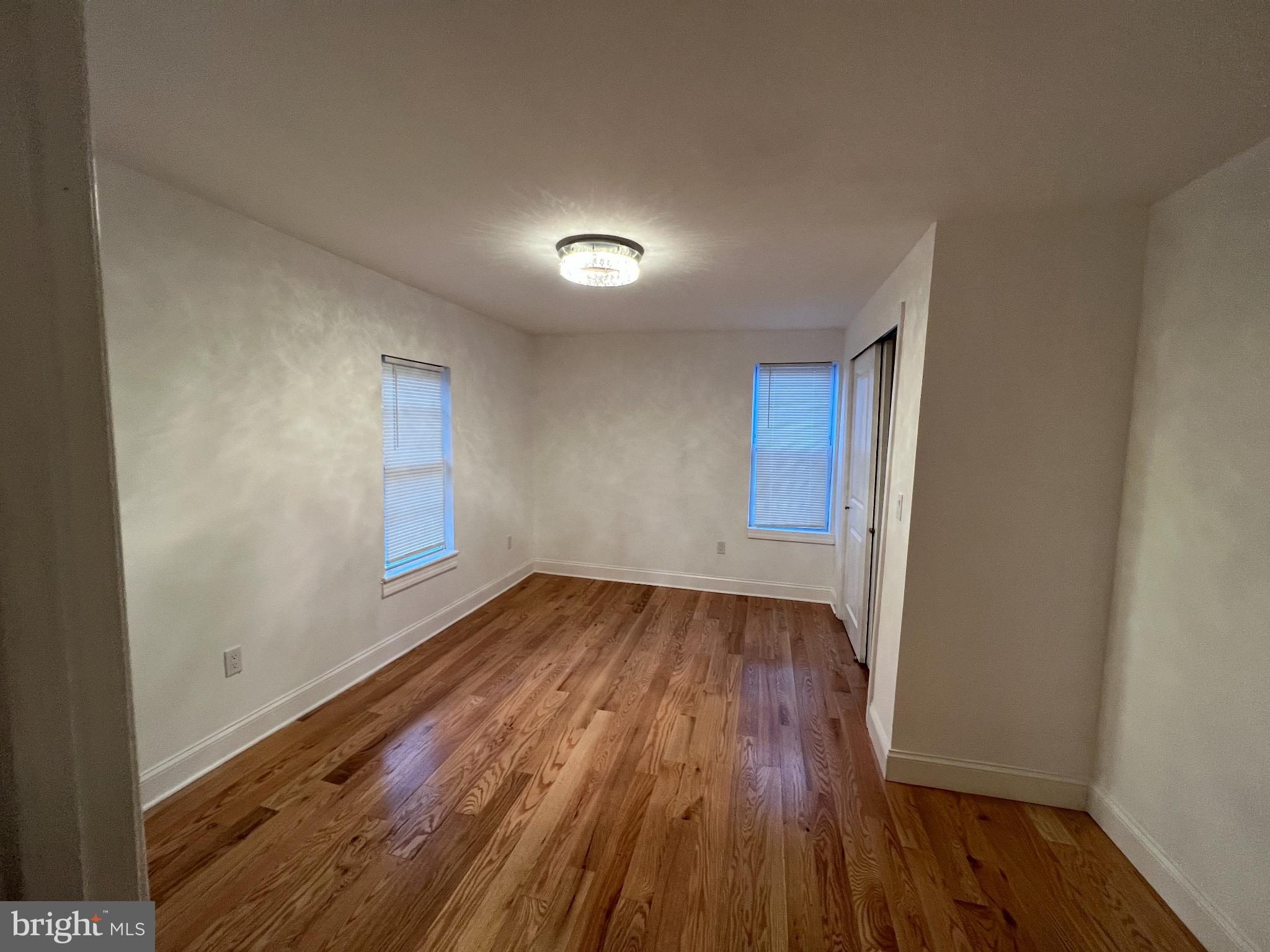 220 Lakeview Avenue Haddonfield, NJ 08033 - Photo 8 of 11 wooden floor in an empty room with a window