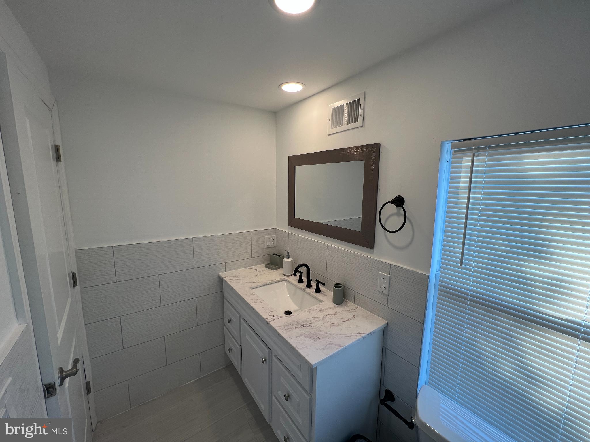 220 Lakeview Avenue Haddonfield, NJ 08033 - Photo 10 of 11 a bathroom with a sink a vanity and a mirror