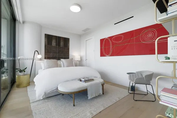 a spacious bedroom with a bed and furniture