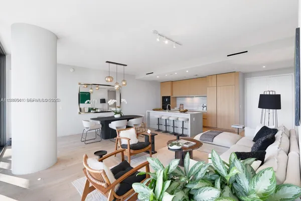 a living room with furniture a wooden floor and a sink