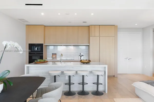 a kitchen with stainless steel appliances granite countertop a sink and a stove