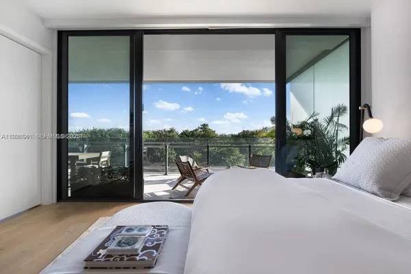 a balcony with furniture and a floor to ceiling window