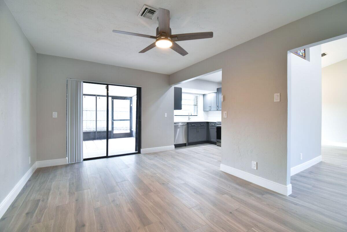 9425 Longmeadow Circle Boynton Beach, FL 33436 - Photo 13 of 34 a view of an empty room with a window and wooden floor