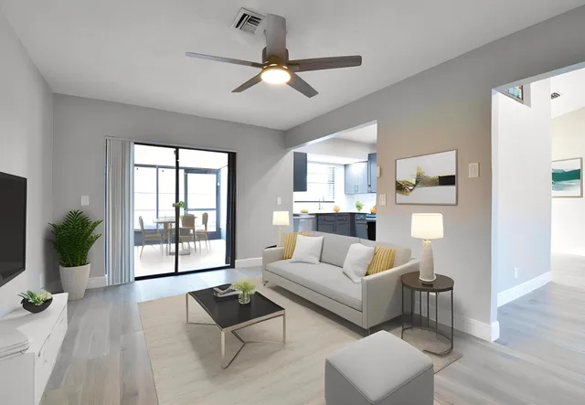 a living room with furniture and a wooden floor