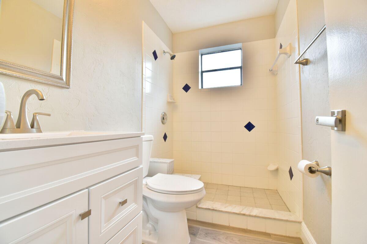 9425 Longmeadow Circle Boynton Beach, FL 33436 - Photo 19 of 34 a bathroom with a toilet and a shower