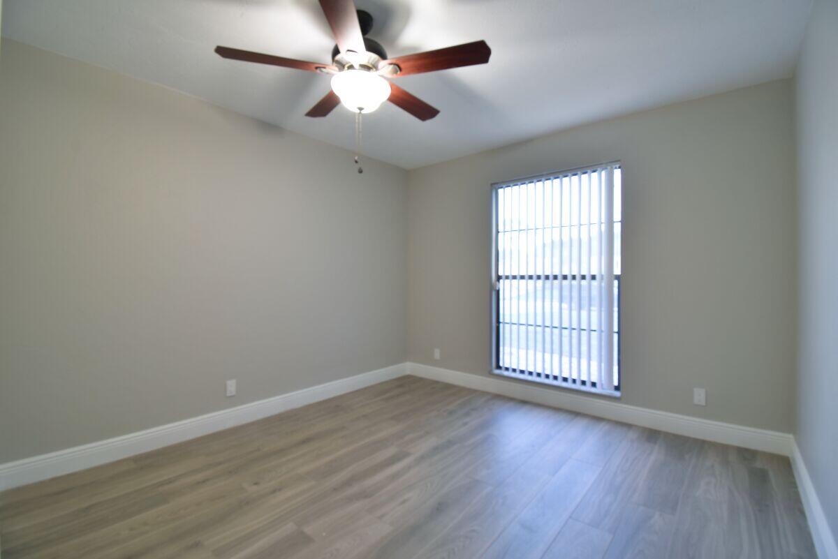 9425 Longmeadow Circle Boynton Beach, FL 33436 - Photo 22 of 34 wooden floor in an empty room with a window