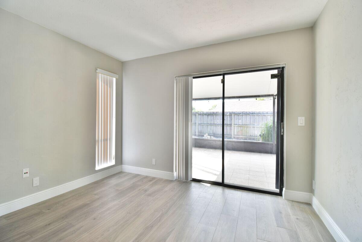 9425 Longmeadow Circle Boynton Beach, FL 33436 - Photo 24 of 34 a view of a room with wooden floor and sliding glass door