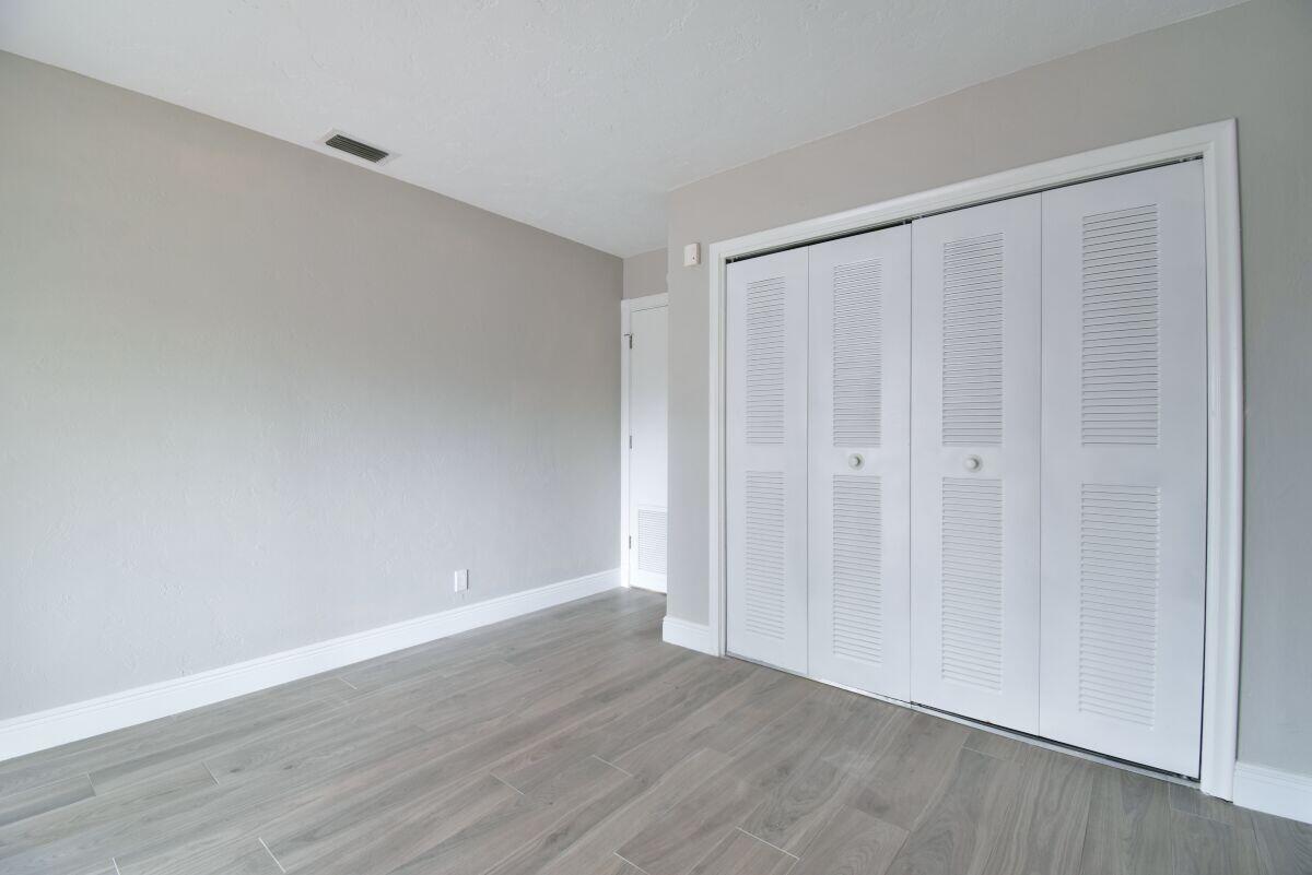 9425 Longmeadow Circle Boynton Beach, FL 33436 - Photo 25 of 34 a view of an empty room with wooden floor