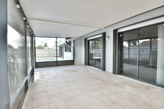 a view of an empty room with glass door